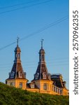 Scandinavian Danish architecture in beautiful city of Copenhagen under afternoon sun golden hour. Tourism in Denmark and capital cities. 150 years old antique building. Downtown Nordic European cities