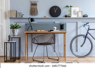 Scandinavian Interior Design Of Home Office With Wooden Desk, Modern Chair, Wood Paneling With Shelf, Plant, Carpet, Bicycle, Office Supplies, Marble Stools And Elegant Personal Accessories.