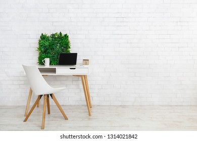 Scandinavian and minimalistic style. Modern workplace with laptop and flowerbox, empty space