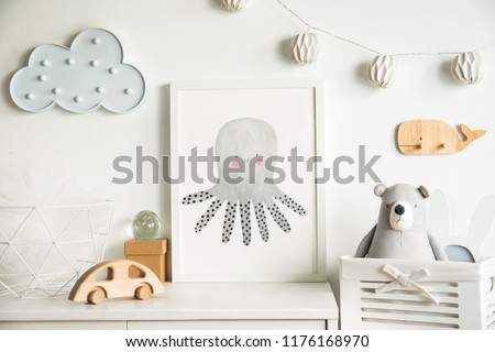 Scandinavian newbornbaby shelf with mock up photo frame, wooden accessories, toys, teddy bear and hanging cloud. White and cozy childroom. 