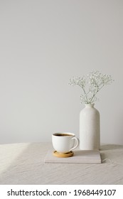 Scandinavian, Nordic Style Home Interior Decoration. Cup Of Coffee And Vase Of Flower On Linen Fabric On Table. White Wall On Background. Morning, Breakfast Concept