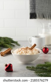  Scandinavian Rice Porridge With Cinnamon In A Bowl Surrounded By Christmas Balls. Breakfast On Christmas Eve.