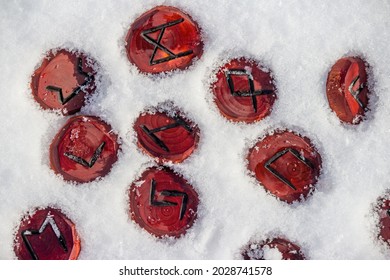 Scandinavian Runes Carved From Wood Lying In The Snow
