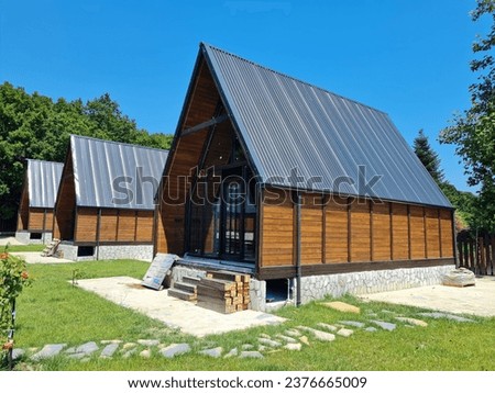 Scandinavian style triangle wooden bungalow.
Barn styled vintage looking wooden house.
Triangular structure.