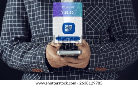 scanning a code to make a mobile payment.scanning invoice qr code and paying with smartphone, over shoulder view. Person using mobile phone 