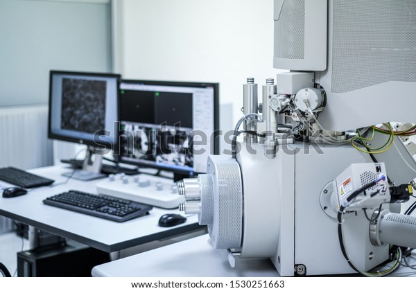 Scanning Electron Microscope\
(SEM) machine and blur computer controller background in\
laboratory