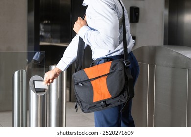 Scanning ID card, business professional entering office building with shoulder bag. corporate, security, entrance, technology, workplace, access - Powered by Shutterstock