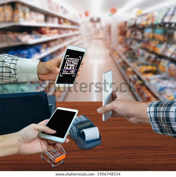 Scanning payment and verification. Businessman holding\
mobile smart phone  scanning  payment, buy and sell products\
.clipping path 