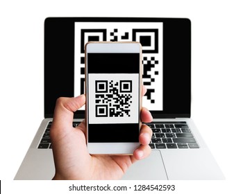 Scanning QR code from screen of laptop using mobile smartphone. Cashless concept