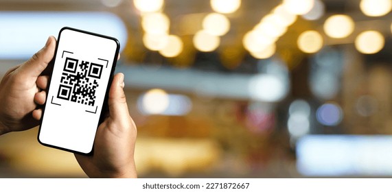 scanning QR codes with a mobile phone application and paying for goods and services in the retail supermarket background