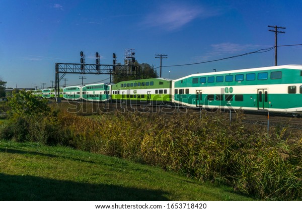 Scarborough, Ontario,
Canada, Oct 2017 - Go train passing under a railroad signal bridge
at Scarborough