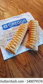 Scarborough, UK - May 18th, 2019: Two Greggs Vegan Sausage Rolls Placed On Paper Bag. Introduced In January 2019 The Vegan Sausage Roll Has Proved Very Popular For The High Street Bakery Chain Greggs.