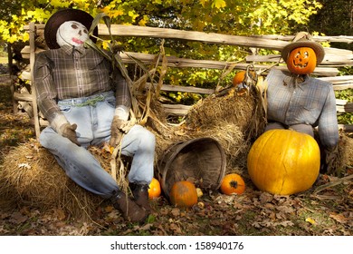 scarecrow and pumpkin display during fall harvest