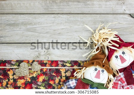 Scarecrows, fall decor and rope hearts border on blank rustic wood sign background