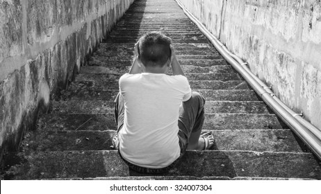 Scared And Alone, Young Homeless Asian Child Who Is At High Risk Of Bing Bullied, Trafficked And Abused