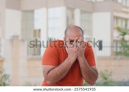 Scared Bald indian Man Looking in the Camera
