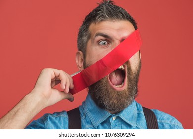 Scared Bearded Man Glued His Face Insulating Tape. Casual Man In Denim Shirt With Tape Covering His Face. Man With Red Duct Tape. Attractive Manager, Businessman With Face Covered By Red Adhesive Tape