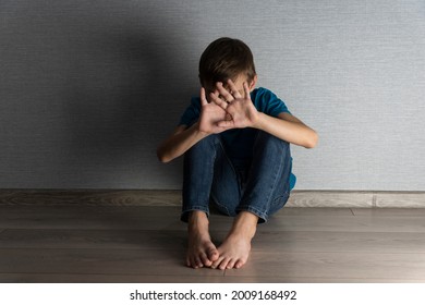 Scared Boy Is Closing His Head And Face With Hands Hiding From Abusing Situation. Home Violence, Emotional Trauma In Unhappy Childhood.