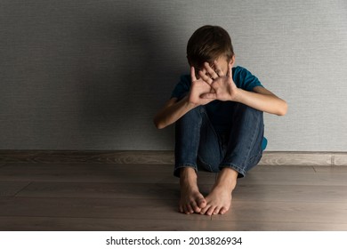 Scared Boy Is Closing His Head And Face With Hands Hiding From Abusing Situation. Home Violence, Emotional Trauma In Unhappy Childhood.