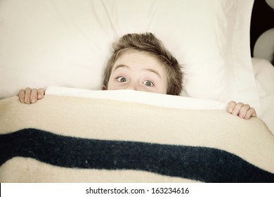 Scared Boy Hiding In Bed