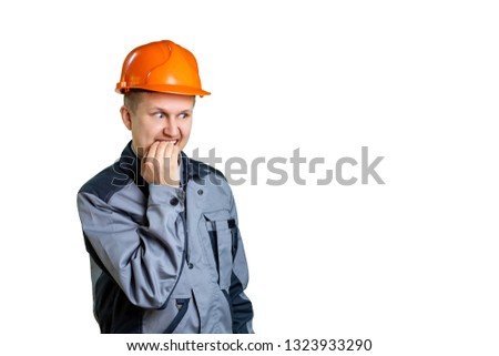 A scared builder worker closes his mouth from fear. Isolated on white background. Construction mistake.