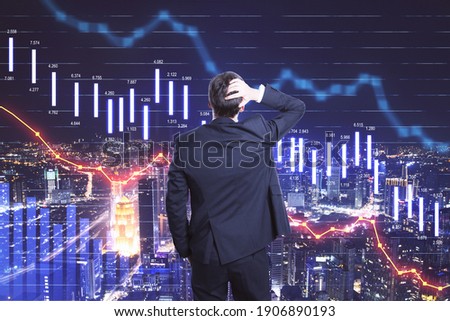 Scared businessman looking on falling stock market statistics hologram. Business and financial crisis concept. Multiexposure