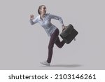 Scared businesswoman escaping from danger, she is running away and looking backwards, isolated on gray background