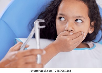 Scared, child or hands of dentist with tool for dental health, teeth cleaning or cavity treatment for oral hygiene. Pediatric clinic, nervous girl or worried kid with fear for medical consultation - Powered by Shutterstock