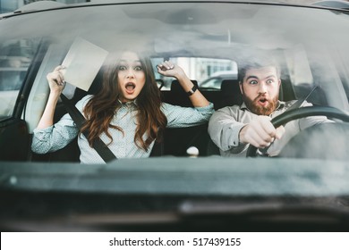 Scared Couple In Car. Front Portrait