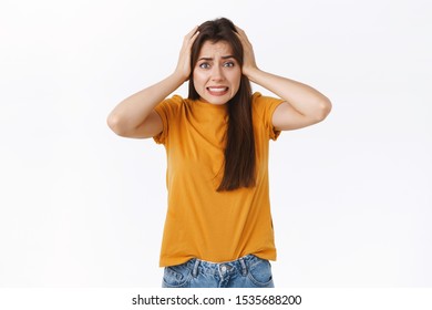 Scared Or Embarrassed Young Attractive Woman, Grab Head, Clench Teeth In Panic And Worry, See Something Dangerous Or Troublesome, Stuck In Difficuly Situation, Standing White Background