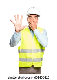 Scared engineer against white background