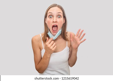 Scared and frightened woman with freckles keeps mouth opened and looks on camera. She is impressed, amazed and excited. Isolated on grey background. - Shutterstock ID 1215619042