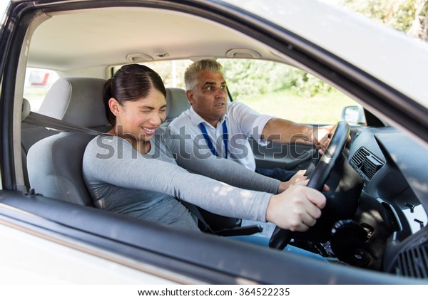 scared\
girl taking driving lessons for the first\
time