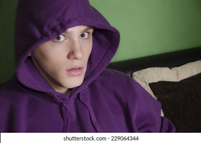 Scared Kid With Purple Hood Looking At Camera. Anxiety