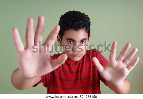 scared-latin-boy-making-stop-gesture-stock-photo-edit-now-574963150