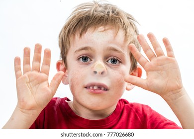 scared little 7-year old child acting for the concept of hostage, violence and sadness, crushing his stuck face and goofy nose to a window with his hands, white background