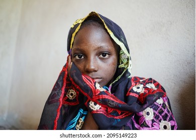 Scared little african girl going to be married to an unknown man; forced or arranged and child marriage concept for women’s and girl’s rights
