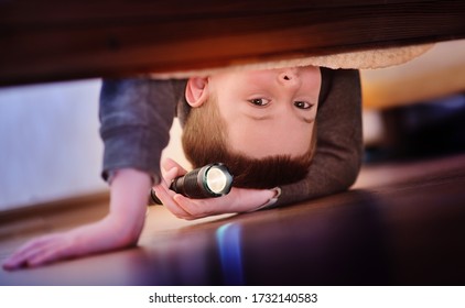 A Scared Little Child Boy Looks Under The Bed With A Flashlight On. Fear Of The Dark, Children's Fears.