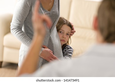 Scared Little Girl Hiding Behind Mother From Violent Father