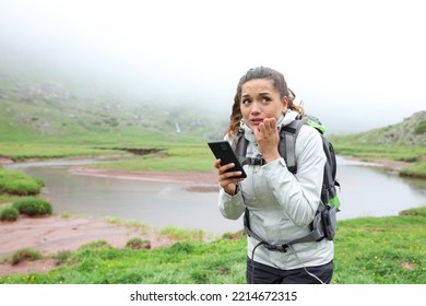 Scared Lost Hiker Checking Smart Phone In The Mountain