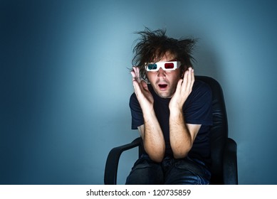 Scared Man With 3d Anaglyph Glasses In Cinema Chair