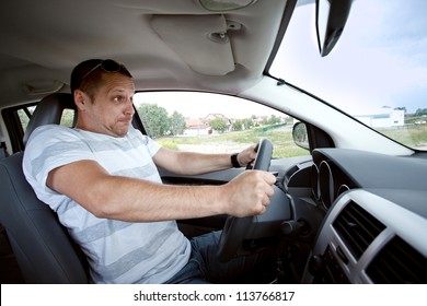 Scared Man Driving Car Very Fast,  Focused On The Driver's Face