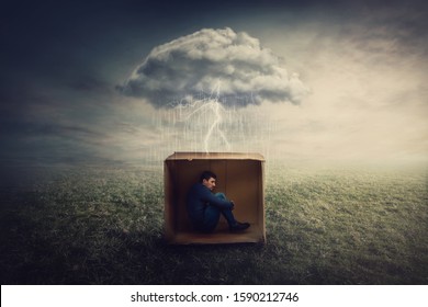 Scared Man Shelters Inside A Cardboard Box. Depressive Introvert Person Caged By Fears As Thunderstorm Trapped Him. Emotional Crisis During COVID-19 Quarantine, Lockdown Home Isolation Concept.