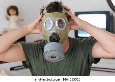 Scared Man Wearing Gas Mask At Home