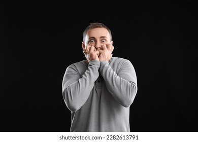 Scared mature man on black background - Shutterstock ID 2282613791