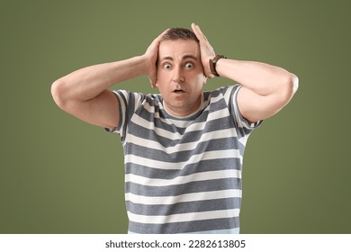 Scared mature man on green background - Shutterstock ID 2282613805