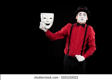 Scared Mime Holding White Mask Isolated On Black