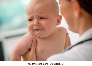 Scared Neonate Looking Away During A Medical Exam