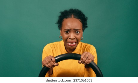 Scared and nervous learner driver behind the wheel, driving studio