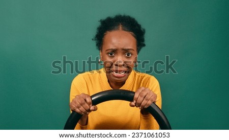 Scared and nervous learner driver behind the wheel, driving studio